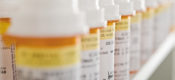 Bottles of pills arranged in shelf at a drugstore